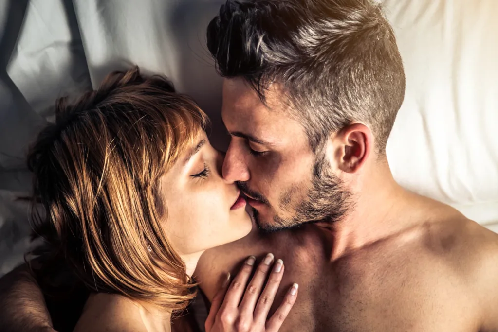 yatakta uzanan çiftlerin erotik öpüşmeleri