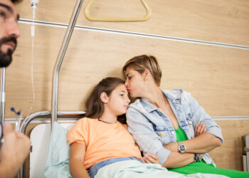 Doctor visitin her patient in hospital room